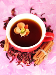 Herbal tea in cup, on color wooden background