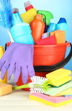 Cleaning items in bucket on  color background
