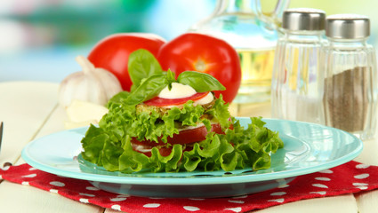 Tasty roasted marrow and tomato slices with salad leaves,
