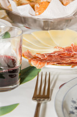 Typical spanish tapa with slices of serrano ham and manchego che