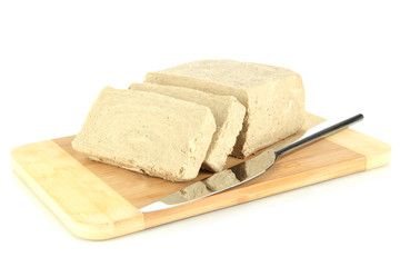 Tasty halva on cutting board isolated on white