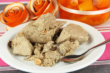 Tasty halva with tea on table close-up