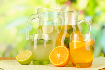 Orange and lemon lemonade in pitchers and glasses