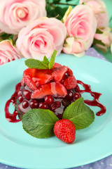 Tasty jelly dessert with fresh berries, on bright background