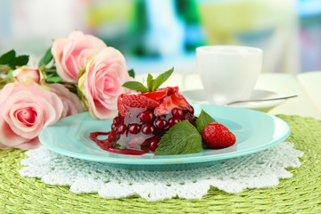 Tasty jelly dessert with fresh berries, on bright background