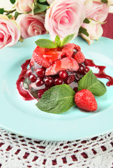 Tasty jelly dessert with fresh berries, on pink roses