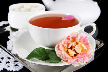 Kettle and cup of tea from tea rose