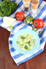 Cabbage soup in plates on napkin on wooden table