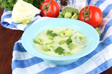 Cabbage soup in plates on napkin on wooden table