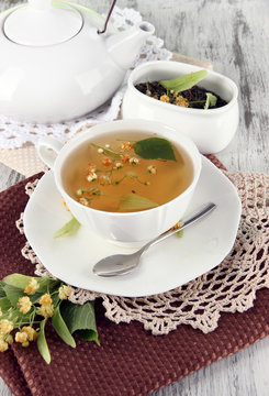 Cup of tea with linden on napkins on    wooden table