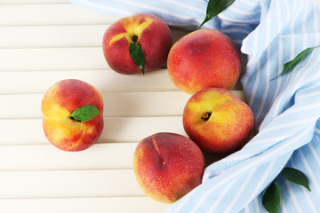 Peaches on napkin on wooden table