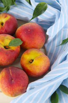 Peaches on napkin on wooden table