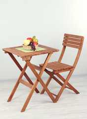Wooden table with fruit in room