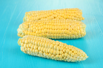 Fresh corn on color wooden background