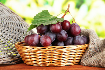 Ripe delicious grapes in wicker basket