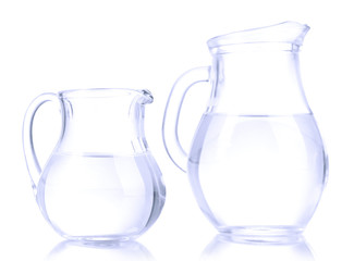 Glass pitchers of water isolated on white