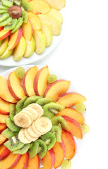 Naklejka na ściany i meble Assortment of sliced fruits on plates, isolated on white