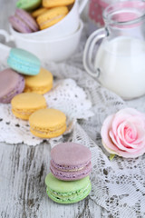 Macaroons in bowl on wooden table close-up