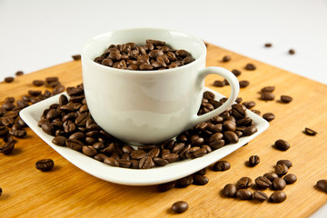beans of  coffee and cup on the plate