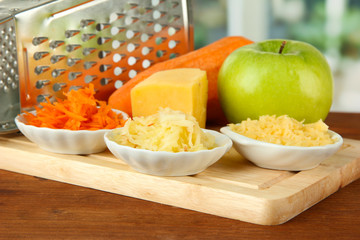 Metal grater and apple, cheese, carrot,