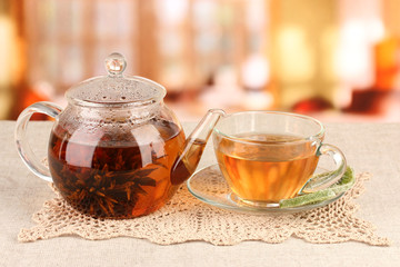 Exotic green tea with flowers in glass teapot