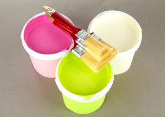 Set for painting: paint pot, brushes on grey background