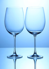Empty wine glasses arranged on blue background