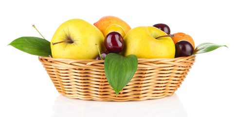 Bright summer fruits in basket isolated on white