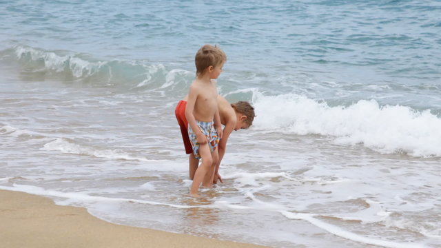 Boys standing on beach