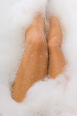 Legs of female in the bathtub