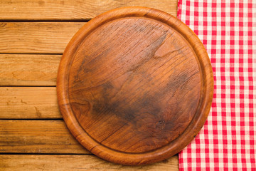 Bread board on wooden background with tablecloth