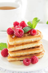 Waffles with raspberry, honey and chocolate.