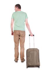 Back view of man with  suitcase looking up