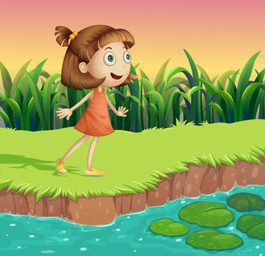 A small girl at the riverbank