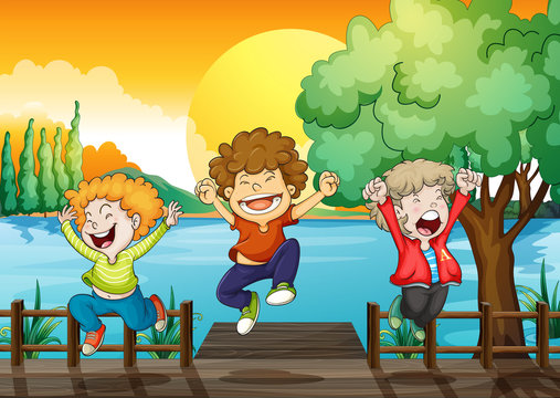 Three happy boys at the wooden bridge