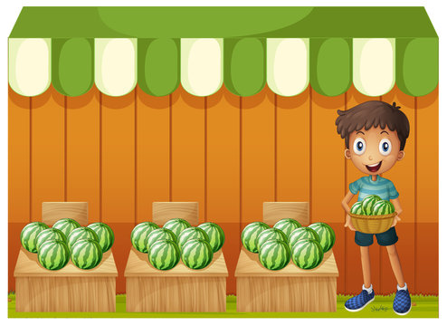 A boy holding a basket of watermelons