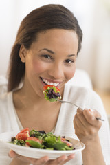 Happy Woman Eating Fresh Salad At Home