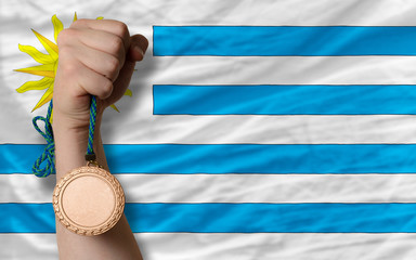Bronze medal for sport and  national flag of uruguay