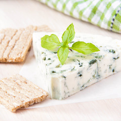 Blue cheese with a noble mould with diet bread and basil