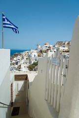 white - blue Santorini, Oia, view with Greek flag and mill