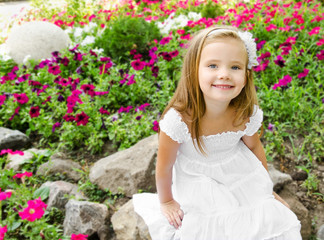 Adorable little girl sitting in the park