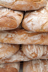 loaves of crispy traditional bread on farmers market in Tuscany