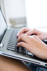 Woman hands typing on laptop