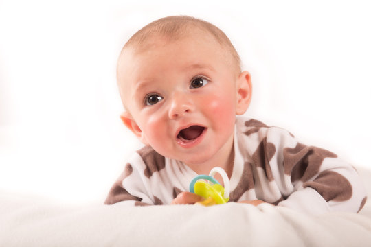 Portrait of sitting little baby boy on a white background
