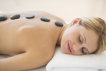 Obraz na płótnie Canvas Woman Getting Hot Stone Therapy At Health Spa