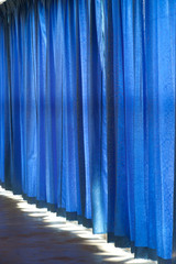 Close view of a blue curtain.