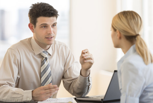 Businessman Discussing With Colleague In Meeting At Office