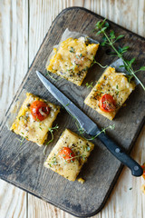 Polenta slices with cherry tomatoes, top view
