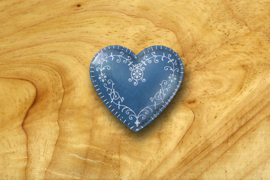 Blue heart on old wood background