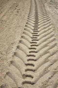 Wheel track on sand background